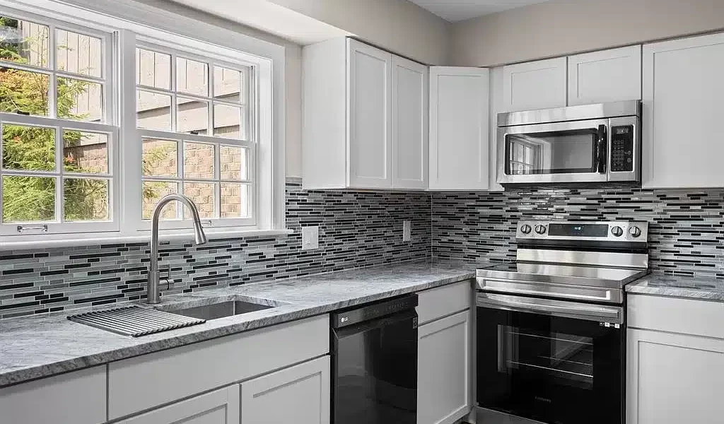 A Large Kitchen With Stainless Steel Appliances