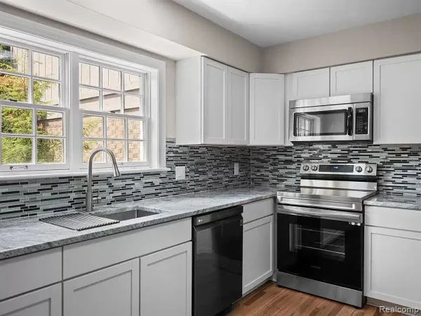 A Large Kitchen With Stainless Steel Appliances