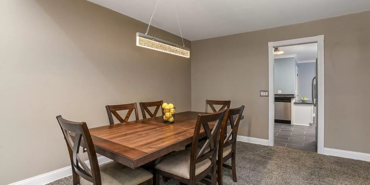 A Bedroom With A Bed And A Chair In A Room