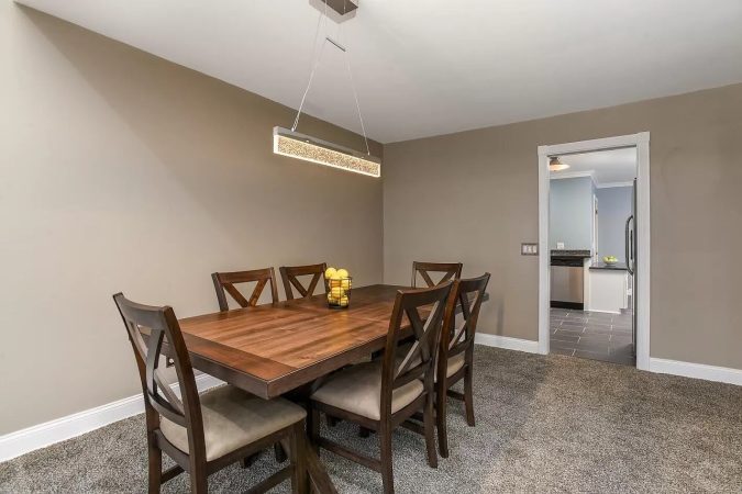 A Bedroom With A Bed And A Chair In A Room