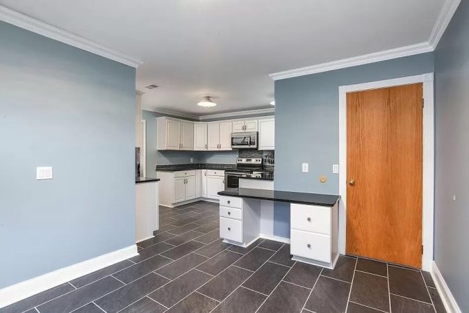 A Kitchen With A Building In The Background