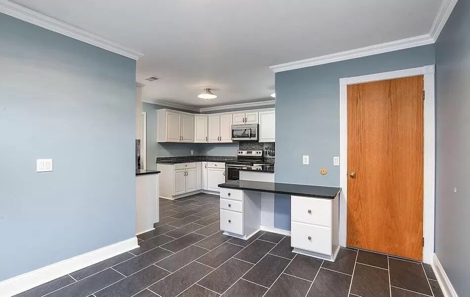 A Kitchen With A Building In The Background
