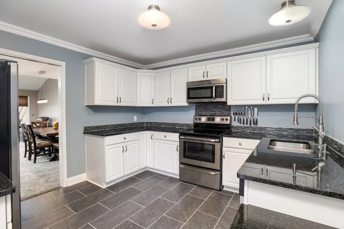 A Kitchen With A Stove Top Oven