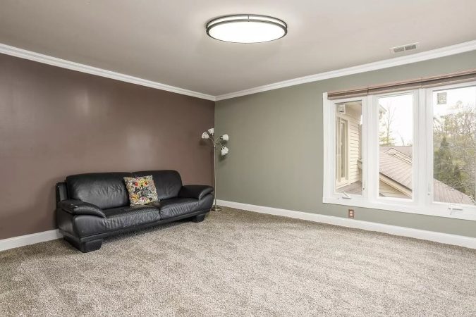 A Bedroom With A Large Window