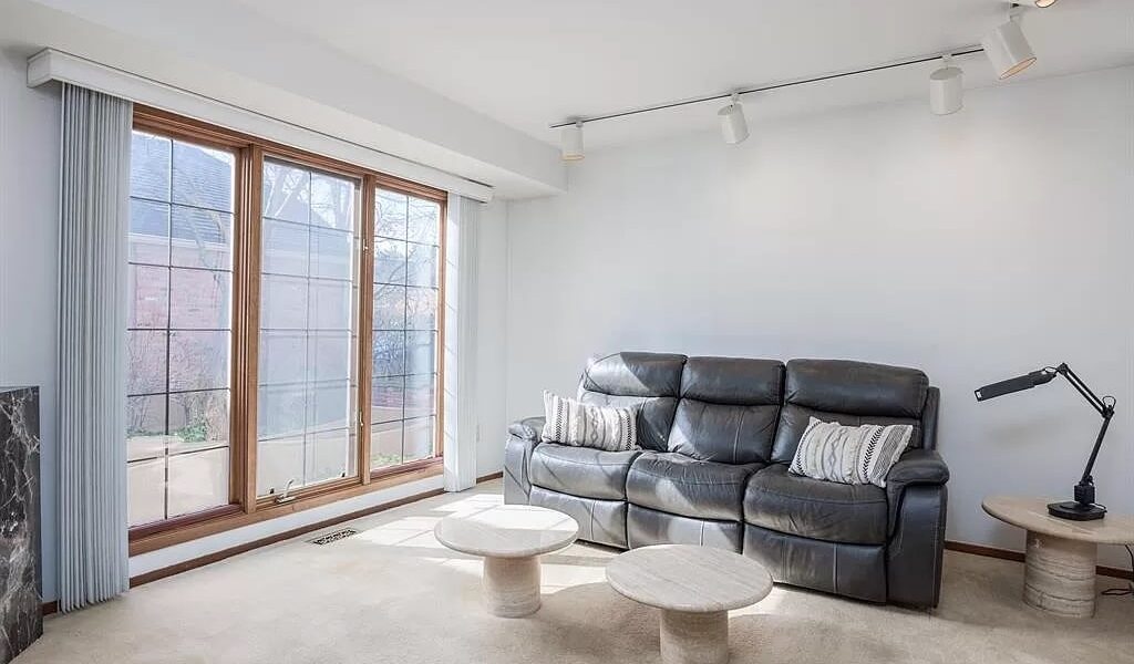 A Living Room Filled With Furniture And A Large Window