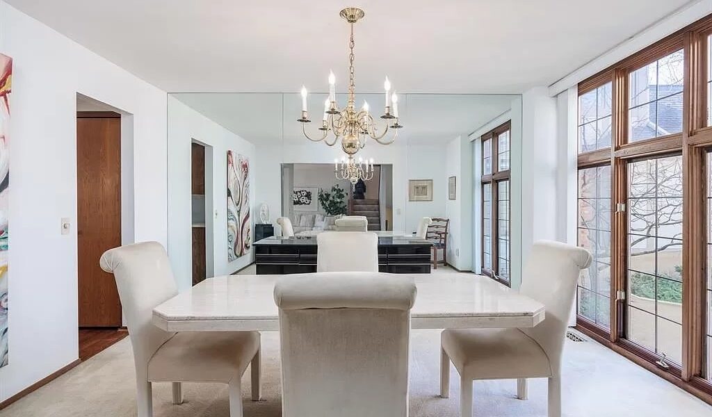 A Living Room Filled With Furniture And A Large Window