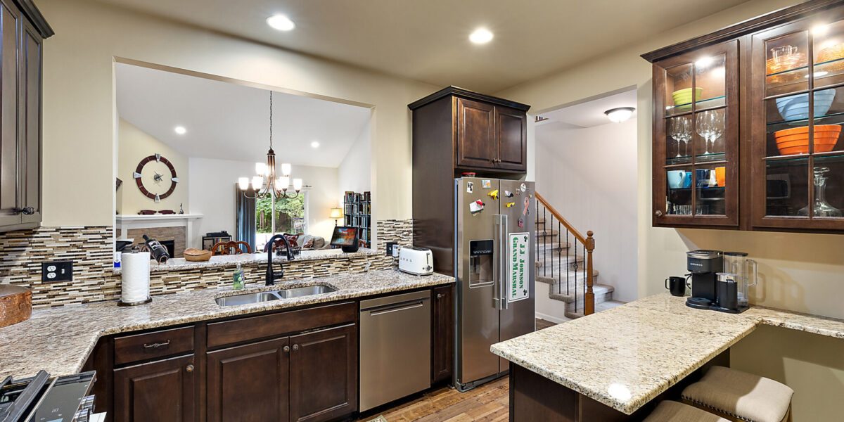 A Modern Kitchen With An Island In The Middle Of A Room