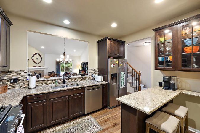 A Modern Kitchen With An Island In The Middle Of A Room