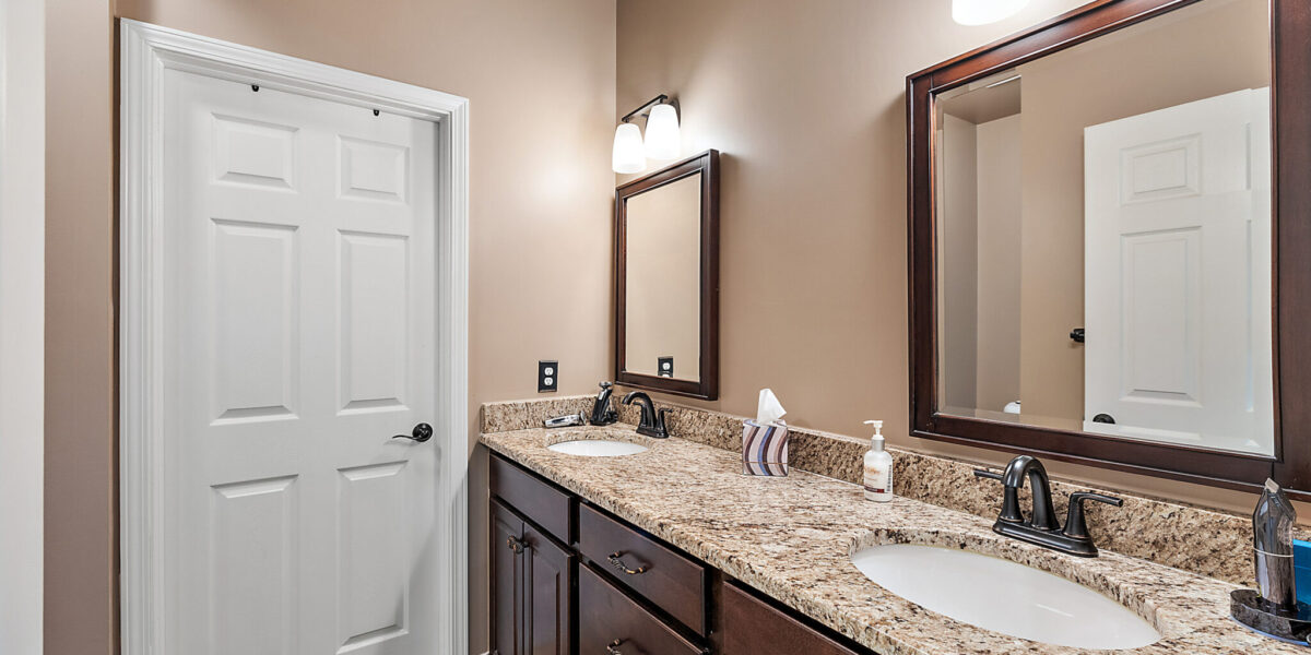 A Kitchen With A Sink And A Mirror