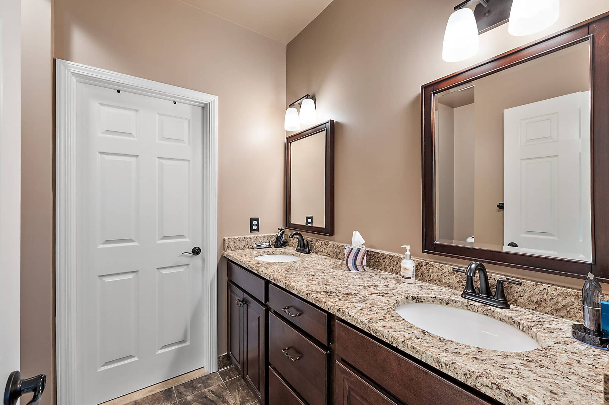 a kitchen with a sink and a mirror