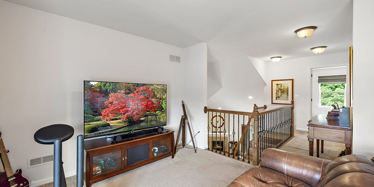 A Living Room Filled With Furniture And A Flat Screen Tv