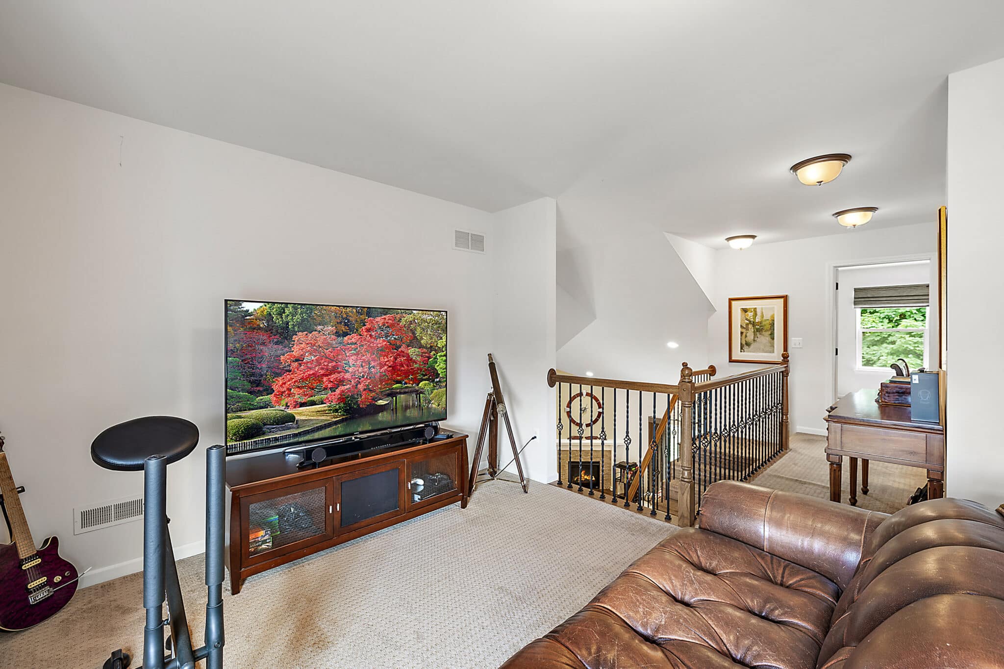 a living room filled with furniture and a flat screen tv