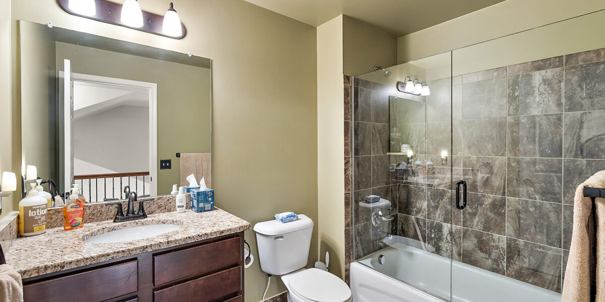 A Room With A Sink And A Mirror