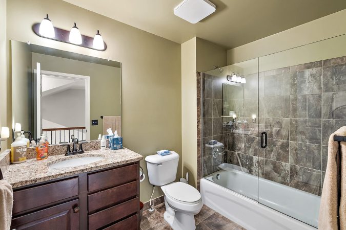 A Room With A Sink And A Mirror
