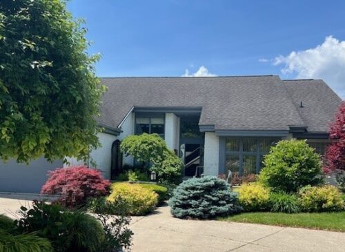 A House With Bushes In The Background