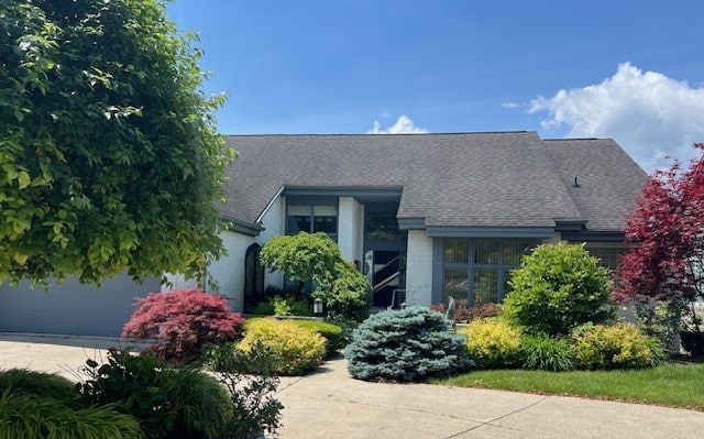 a house with bushes in the background