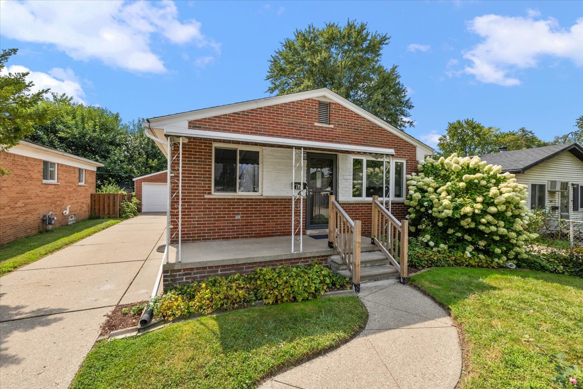 a house with a lawn in front of a brick building