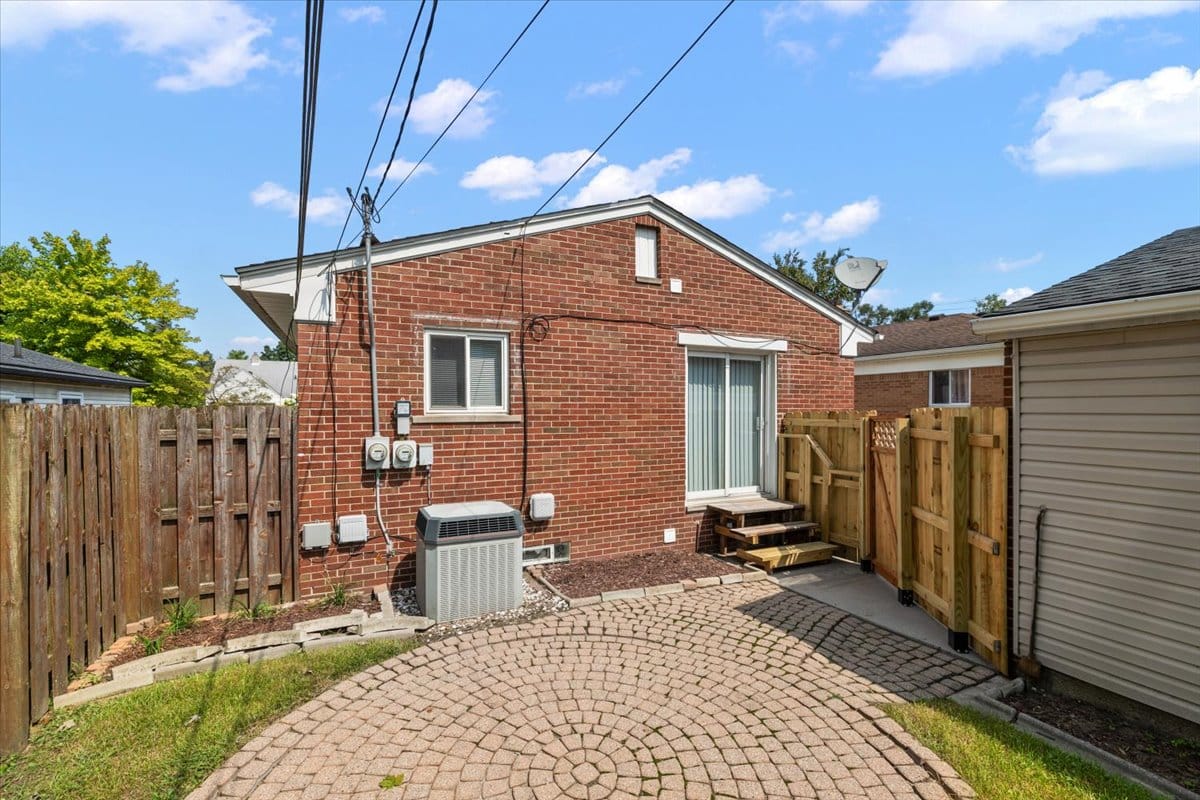 a large brick building with a wooden fence