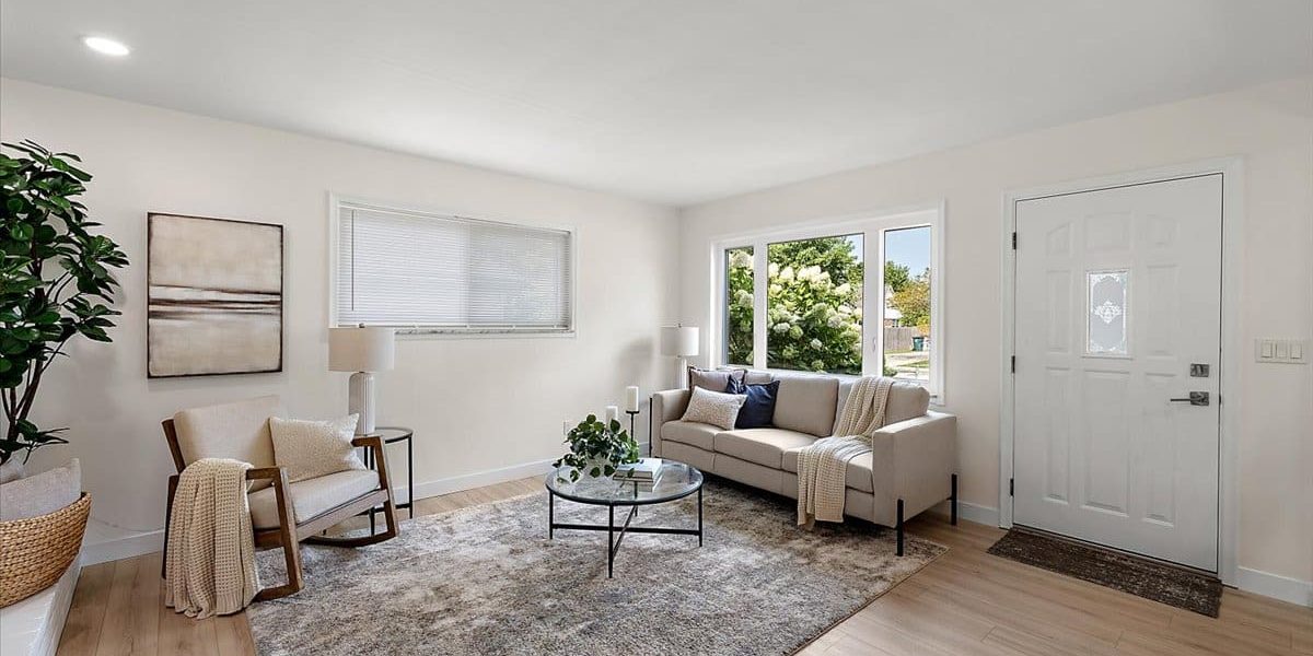 A Living Room Filled With Furniture And A Large Window