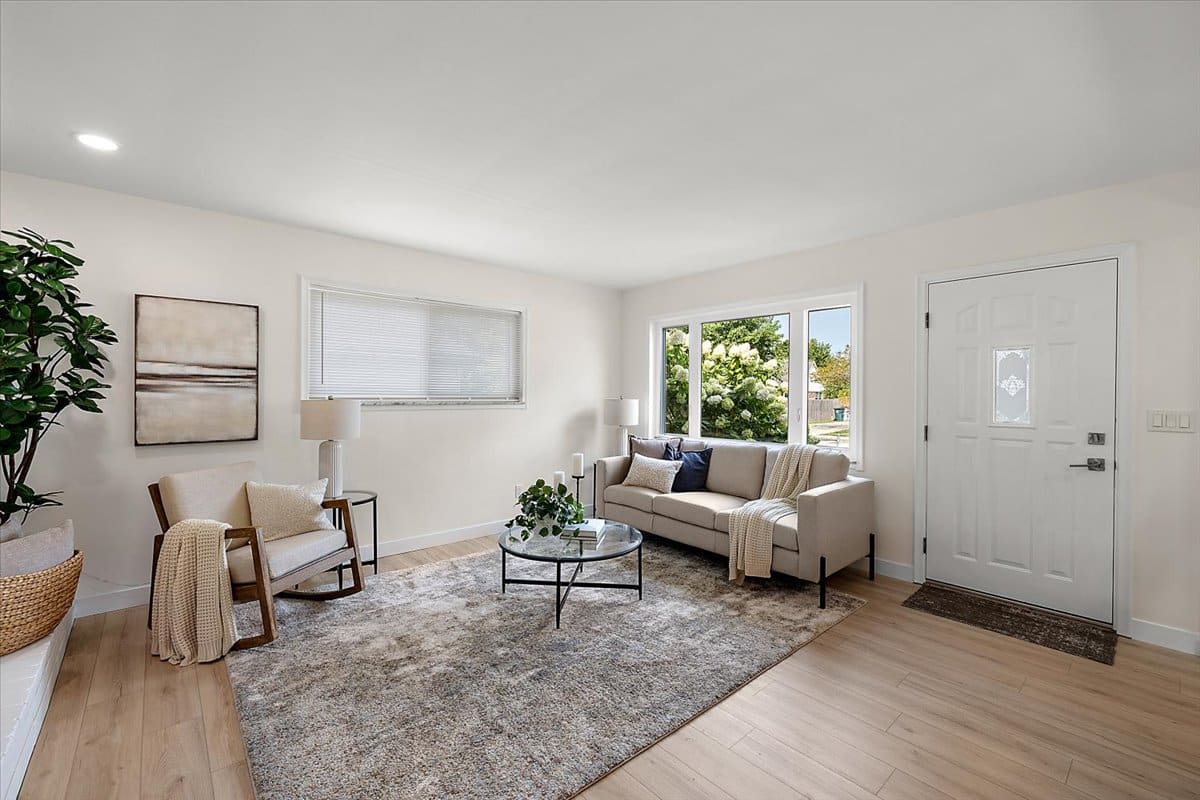 a living room filled with furniture and a large window