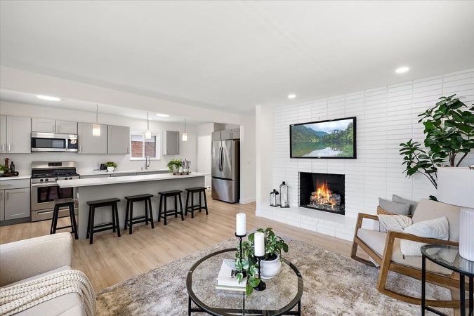 A Living Room Filled With Furniture And A Fire Place