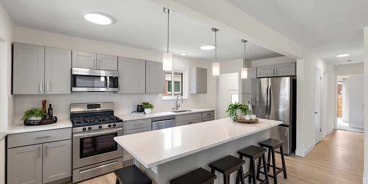 A Kitchen With An Island In The Middle Of A Room