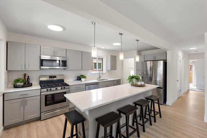 A Kitchen With An Island In The Middle Of A Room
