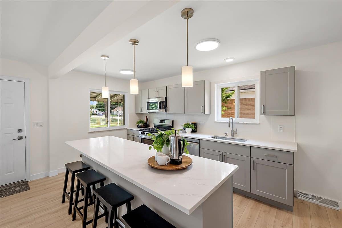 a kitchen with an island in the middle of a table