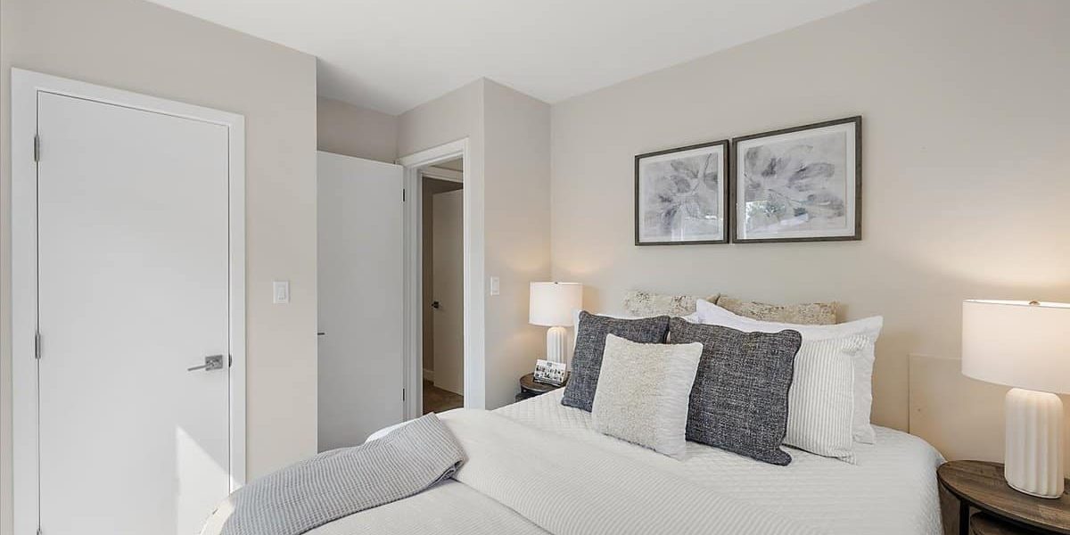 A Bedroom With A Large Bed In A Hotel Room