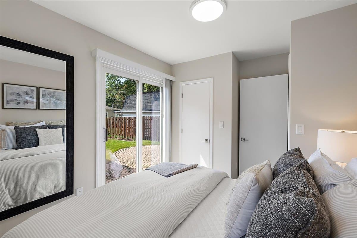 a bedroom with a bed and a large window