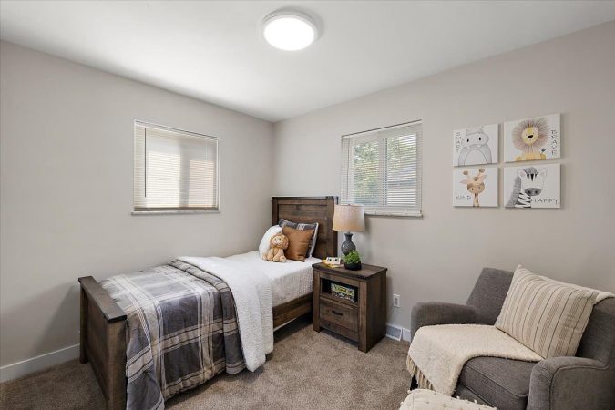A Bedroom With A Bed And A Couch In A Living Room