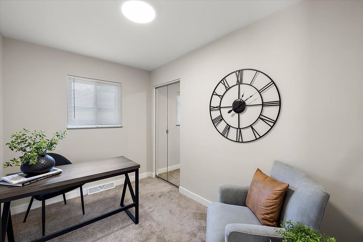 a living room filled with furniture and a flat screen tv