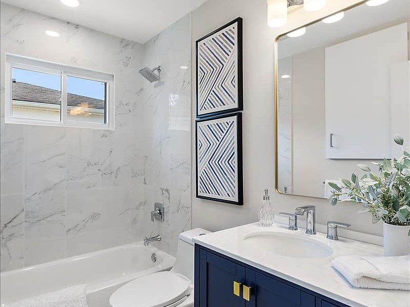 A Room With A Sink And A Mirror