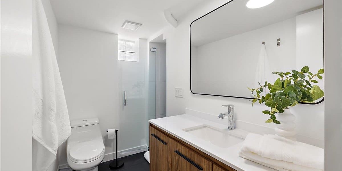 A Bedroom Area With A Sink And A Mirror