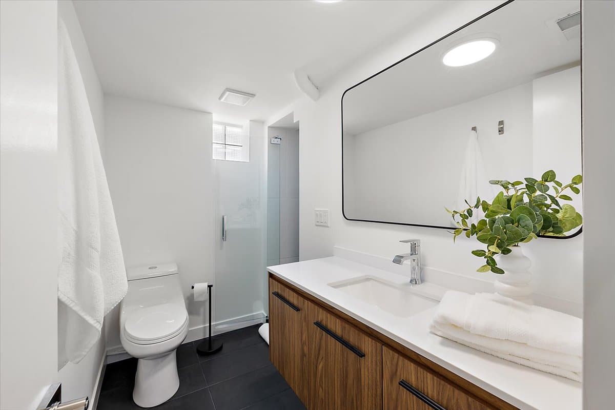 a bedroom area with a sink and a mirror