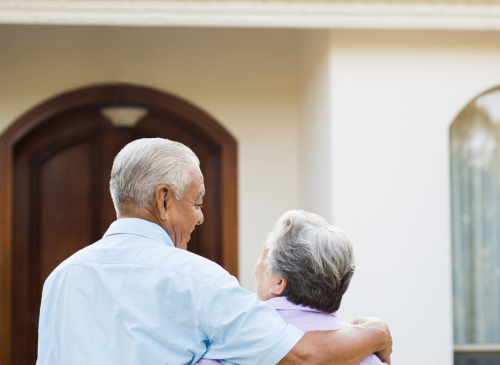 Older Couple Looking At House